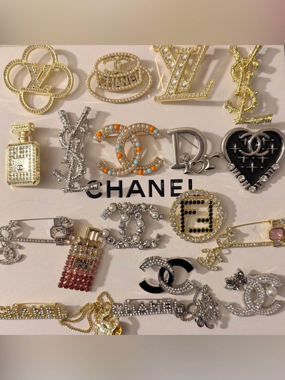 Mixed Gold and Silver Logo Brooch Collection with Accent Stones